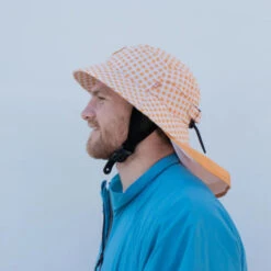 Plow Surf Co. | Orange Gingham | Plow Surf Hat | Surfing Hat | Beach + Water Activity Headwear | 11 Plow Surf Co. | Orange Gingham | Plow Surf Hat | Surfing Hat | Beach + Water Activity Headwear | -FCS Shop Buy Plow Surf Co Orange Gingham Surfing Hat With Chin Strap Side 39565.1692946129